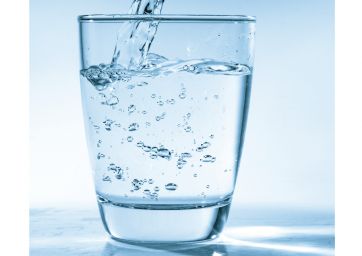 Drinking water is poured into a glass