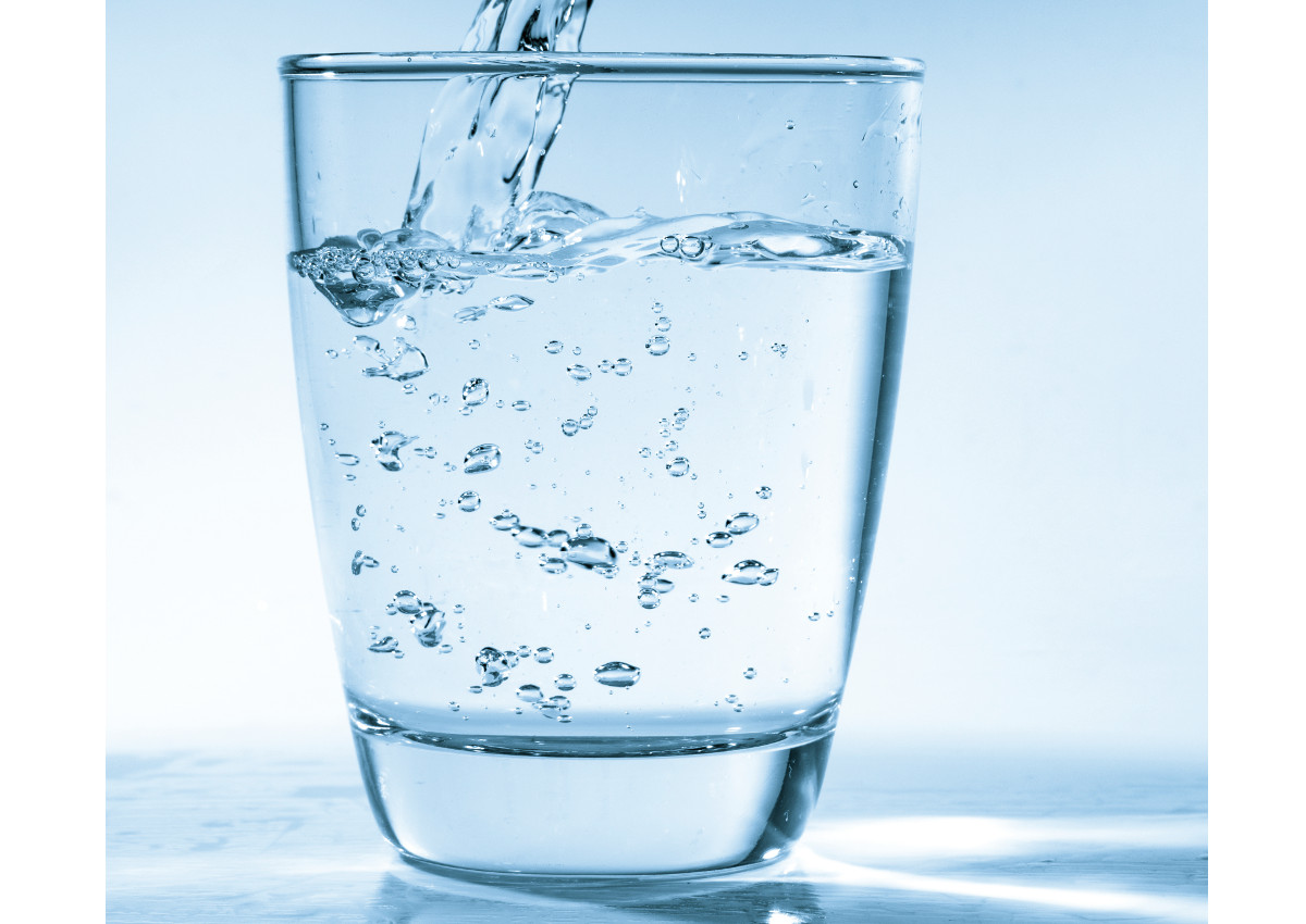 Drinking water is poured into a glass